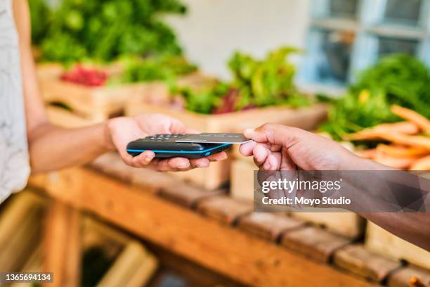 closeup shot of a customer making a credit card payment in a store - tap card stock pictures, royalty-free photos & images