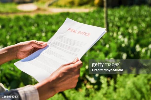 closeup shot of an unrecognisable woman holding a letter of final notice on a farm - information sign stock pictures, royalty-free photos & images