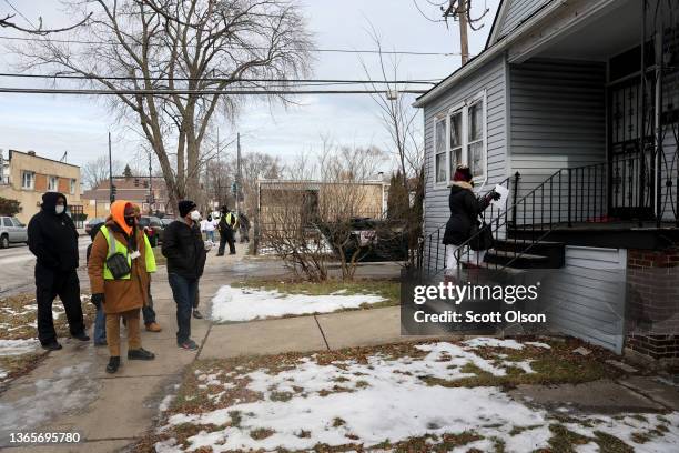 Family members of Tamiko Talbert-Fleming and volunteers distribute flyers seeking information about her murder in the Chicago Lawn neighborhood on...