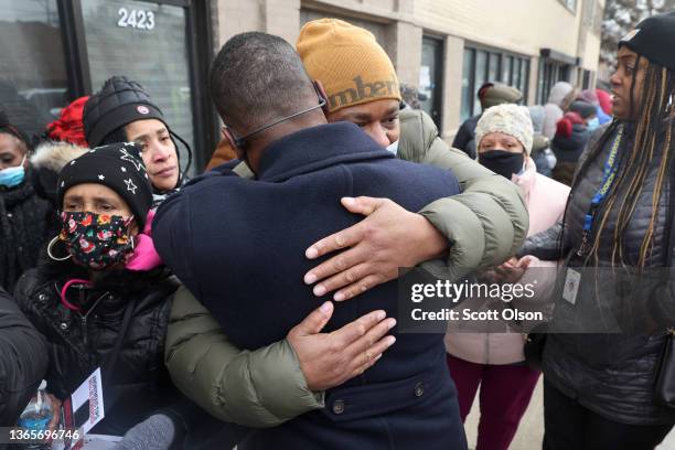 Alfonzo Fleming, the husband of Tamiko Talbert-Fleming, is hugged by Glen Brooks, director of community policing for the Chicago Police Department,...