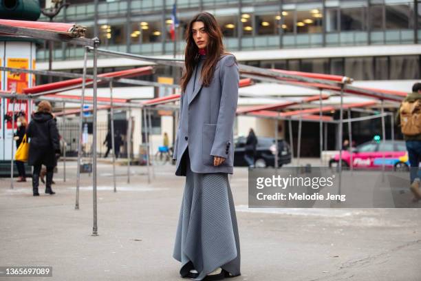 Louise Follain wears a light purple oversized suit jacket with a light blue layered skirt at the AMI Paris show at Palais Brongniart on January 19,...