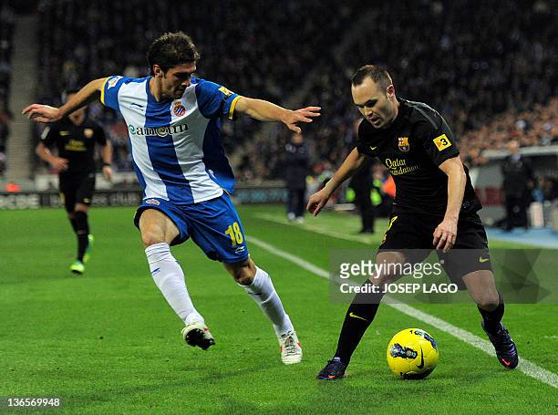 Espanyol's Argentinian defender Juan Forlin vies with Barcelona's midfielder Andres Iniesta during the Spanish league football match RCD Espanyol vs...