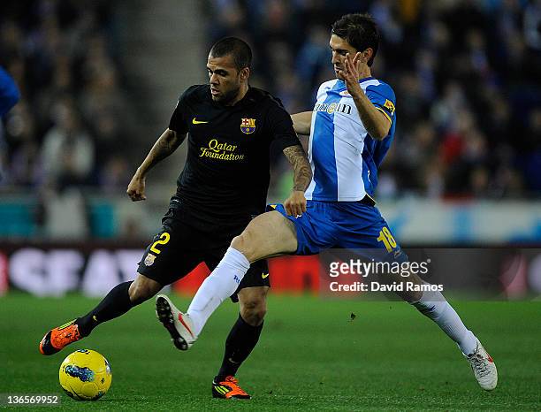 Dani Alves of FC Barcelona duels for the ball with Juan Forlin of RCD Espanyol during the La Liga match between RCD Espanyol and FC Barcelona at...