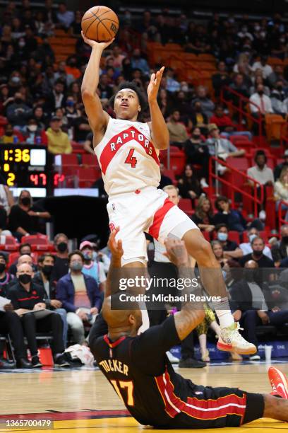 Scottie Barnes of the Toronto Raptors shoots over P.J. Tucker of the Miami Heat during the first half at FTX Arena on January 17, 2022 in Miami,...