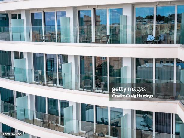 typical european  holiday resort apartments with balconies in island location on the mediterranean. - malta business stock pictures, royalty-free photos & images