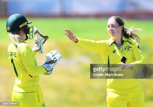 Amanda Jade-Wellington of Australia celebrates the wicket of Ellie Threlkeld of England with Georgia Redmayne of Australia during the First...