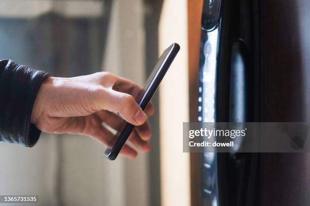 using smart phone to unlock the door - building entrance stock pictures, royalty-free photos & images
