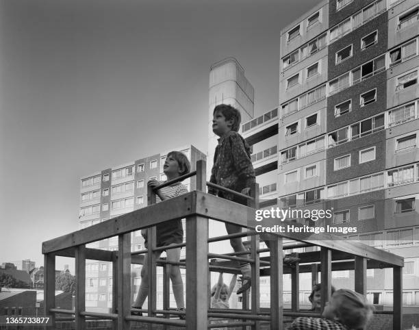 Doddington Estate, Battersea, Wandsworth, London, . Children playing on a climbing frame on the Doddington Estate, with a 10-storey and 13-storey...