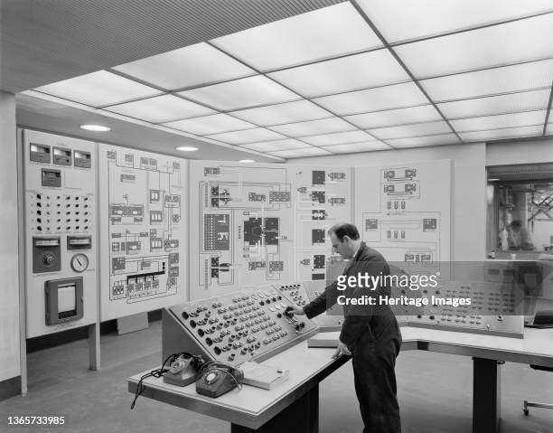 Building, Cooperative Insurance Society Tower, Miller Street, Manchester, . A man operating controls in the basement control room of the Co-operative...