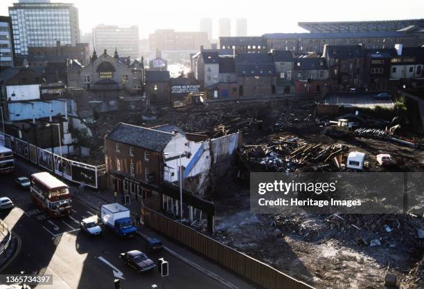 Percy Street, Newcastle upon Tyne, 1987-1988. A view over a demolition site on Percy Street showing the Three Bulls Head pub still standing in the...