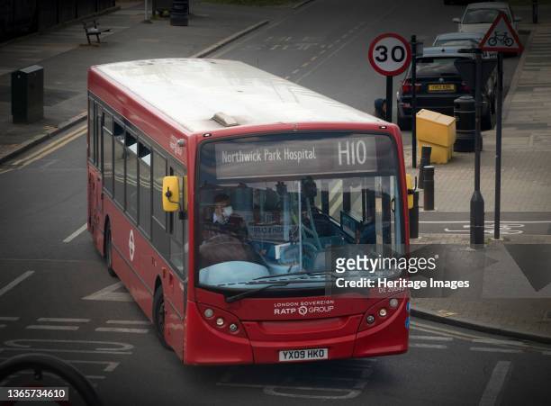An H10 London bus to Northwick Park Hospital during the Covid-19 lockdown, showing the bus driver wearing a protective face mask. The Picturing...