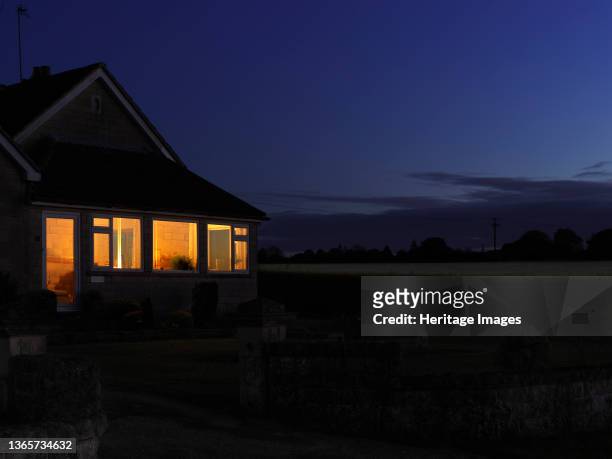 Moonlit and Twilight IV' - A house on Henley Lane at night during the Covid-19 lockdown, showing windows illuminated from within. The Picturing...