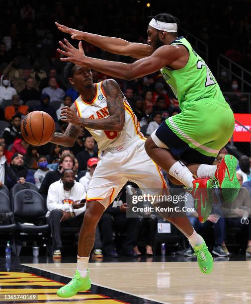 Lou Williams of the Atlanta Hawks looks to pass the ball as he leaps out of bounds against Josh Okogie of the Minnesota Timberwolves during the...