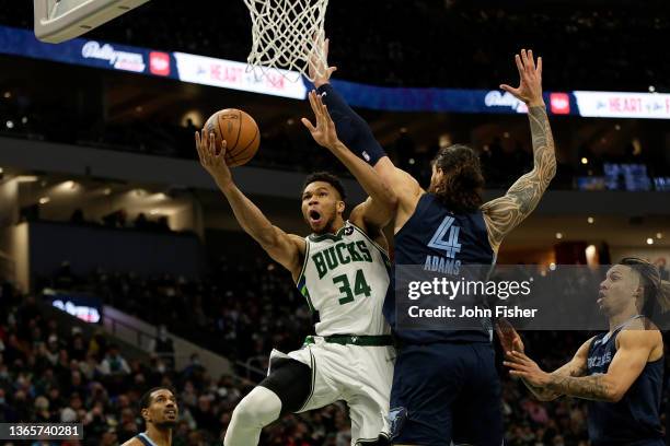 Giannis Antetokounmpo of the Milwaukee Bucks goes up for a shot on Steven Adams of the Memphis Grizzlies at Fiserv Forum on January 19, 2022 in...