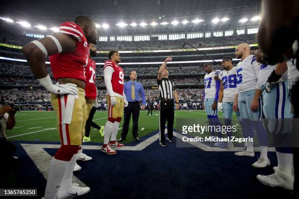 Captains of the San Francisco 49ers and the Dallas Cowboys during the coin toss before the NFC Wild Card Playoff game at AT&T Stadium on January 16,...