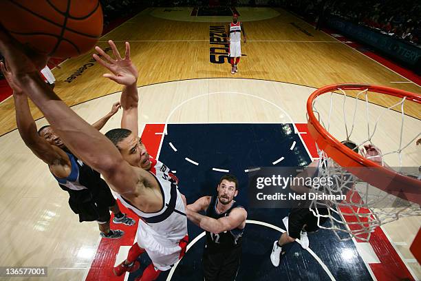 JaVale McGee of the Washington Wizards dunks against Kevin Love of the Minnesota Timberwolves during the game at the Verizon Center on January 8,...