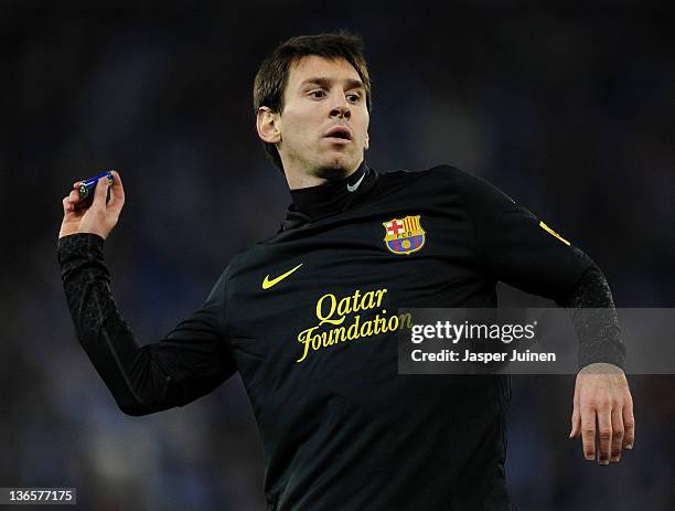 Lionel Messi of FC Barcelona throws back a lighter towards the Espanyol supperters during the la Liga match between RCD Espanyol and FC Barcelona at...