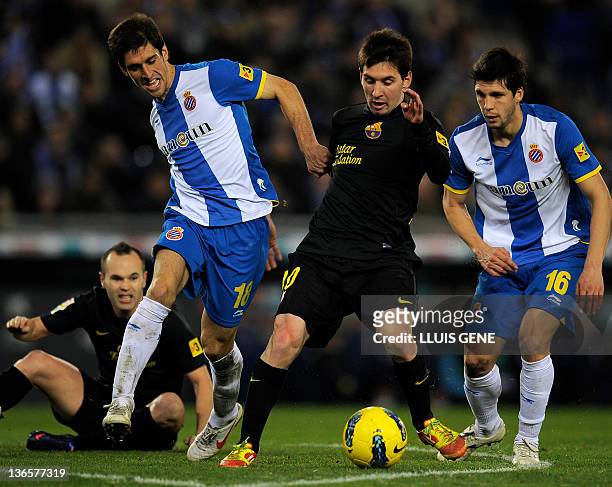 Barcelona's Argentinian forward Lionel Messi vies with Espanyol's Argentinian defender Juan Forlin and Espanyol's midfielder Javier Lopez during the...