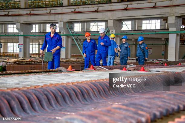 Workers labor at an electrolysis plant of Wuzhou Jinsheng Copper Co Ltd on January 19, 2022 in Wuzhou, Guangxi Zhuang Autonomous Region in China.