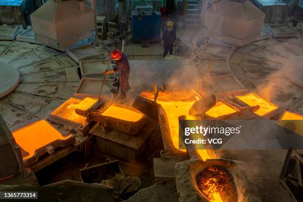 Molten copper flows into molds at a smelting plant of Wuzhou Jinsheng Copper Co Ltd on January 19, 2022 in Wuzhou, Guangxi Zhuang Autonomous Region...