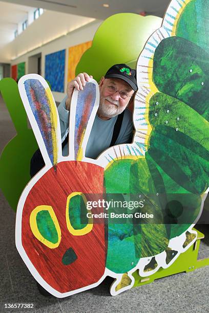 Eric Carle stands with large cutout of the iconic image from his children's book, "The Very Hungry Caterpillar," at The Eric Carle Museum of Picture...