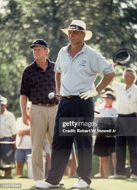 Senior PGA golfer Tom Wargo eyes the tee shot as golfing legend Jack Nicklaus looks on, Palm Beach Gardens FL 1996.