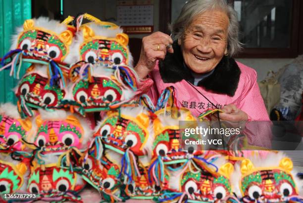 Ninety-four-year-old woman Cui Jinfeng makes tiger-head shoes at Duan village on January 20, 2022 in Jiaozuo, Henan Province of China. Cui Jinfeng...