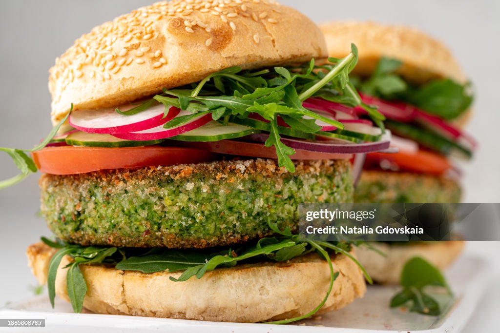 Closeup of vegetarian plant based burgers with veggie patty and sliced vegetables. Fresh vegan snack