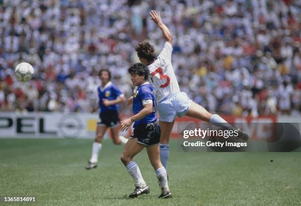 Argentina player Diego Maradona is challenged by England full back Kenny Sansom during the FIFA 1986 World Cup Quarter Final match between Argentina...