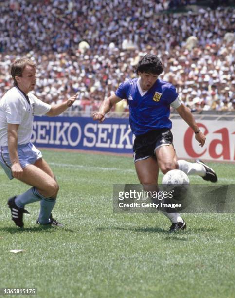 Argentina player Diego Maradona is challenged by England player Trevor Steven during the FIFA 1986 World Cup Quarter Final match between Argentina...