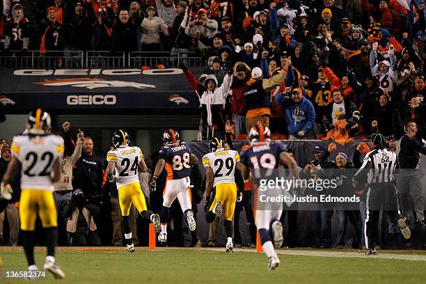 Demaryius Thomas of the Denver Broncos runs the ball after a catch against the Pittsburgh Steelers to score an 80 yard touchdown in overtime of the...