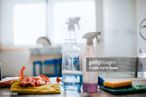 collection of cleaning supplies on surface of the kitchen table - balde imagens e fotografias de stock