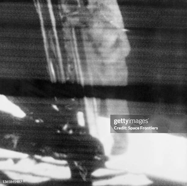 American NASA astronaut Neil A Armstrong descends the ladder of the Apollo 11 Lunar Module to become the first human being to walk on the Moon,...