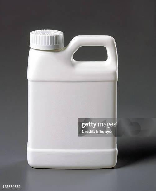 blank white plastic jug on a gray background - jug stockfoto's en -beelden