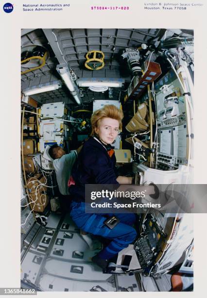 Russian cosmonaut Yelena Kondakova working with the Spacehab Biorack glovebox during Space Shuttle Atlantis mission STS-84, 15th to 24th May 1997....