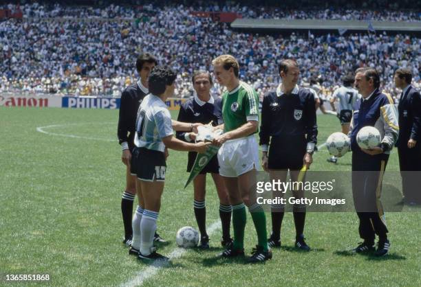 Argentina captain Diego Maradona exchanges team pennants with West Germany captain Karl-Heinz Rummenigge before the FIFA 1986 World Cup final match...