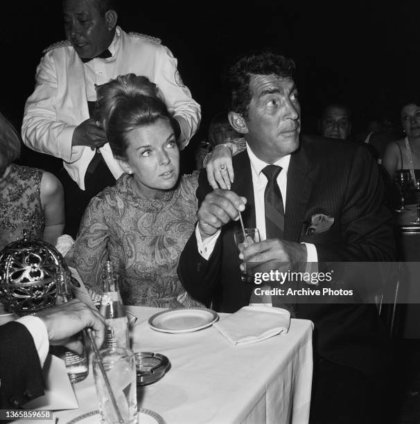 American actor and singer Dean Martin and his wife Jeanne attend singer Eddie Fisher's opening night at the Cocoanut Grove nightclub in Los Angeles,...