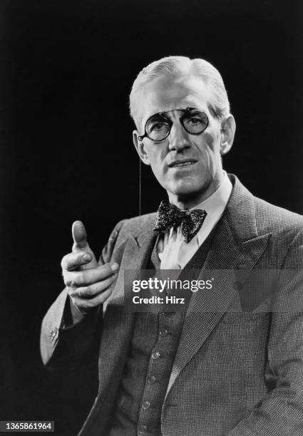 Model G. L. Spaulding poses in a three-piece suit with a bow tie and spectacles, USA, circa 1940.