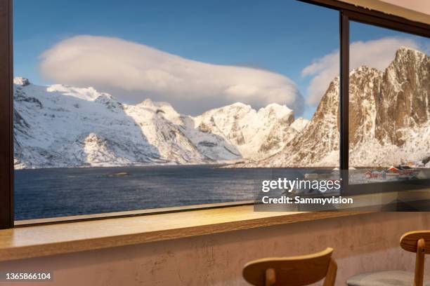 cafe against snowcapped mountain view - moskenesoya stock pictures, royalty-free photos & images