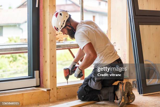 construction worker using electric screwdriver - timber window frames stock pictures, royalty-free photos & images