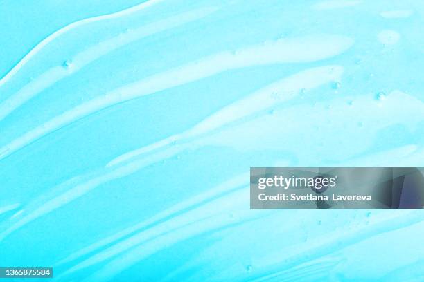 abstract texture. liquid gel cosmetics. blue background. - wet see through fotografías e imágenes de stock