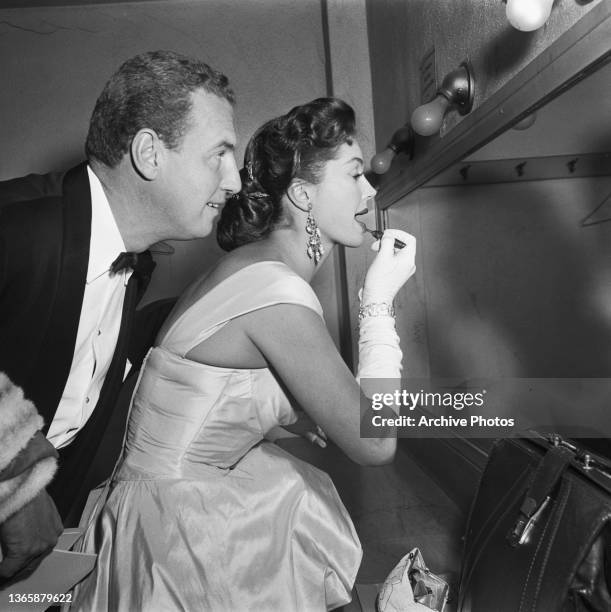 American swimmer and actress Esther Williams touches up her lipstick at the 26th Academy Awards at the NBC Century Theatre in New York City, USA,...