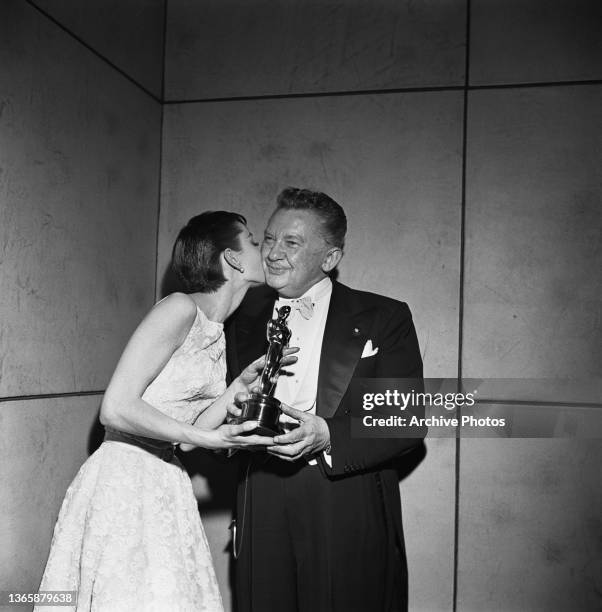 Actress Audrey Hepburn accepts the award for Best Actress for her role in the film 'Roman Holiday' at the 26th Academy Awards at the NBC Century...