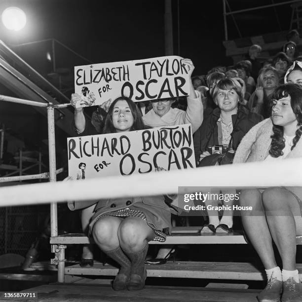 Fans watching the 39th Academy Awards at the Santa Monica Civic Auditorium in Santa Monica, California, USA, 10th April 1967. They are holding up...