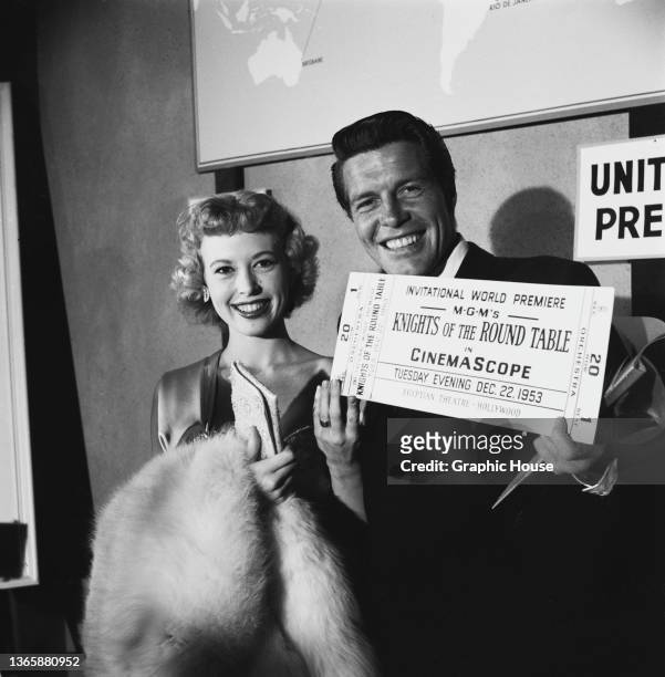 American actress Barbara Ruick and her husband, actor and singer Robert Horton with a large ticket to the world premiere of the MGM film 'Knights of...