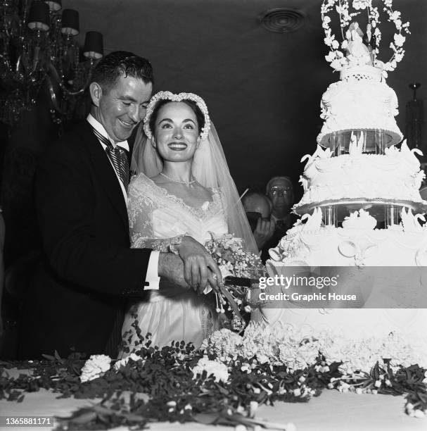 American actress Ann Blyth during her wedding reception in California, USA, 27th June 1953. On the left is her husband, obstetrician James McNulty.