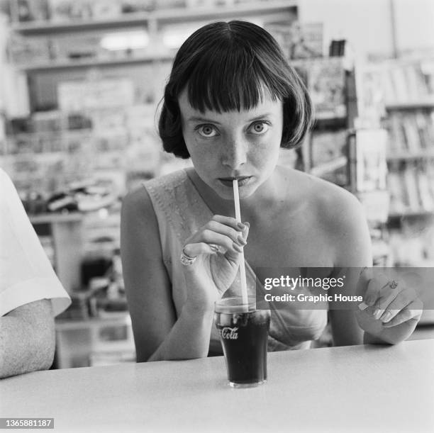 American actress Carolyn Jones drinking a Coca-Cola, USA, circa 1956.