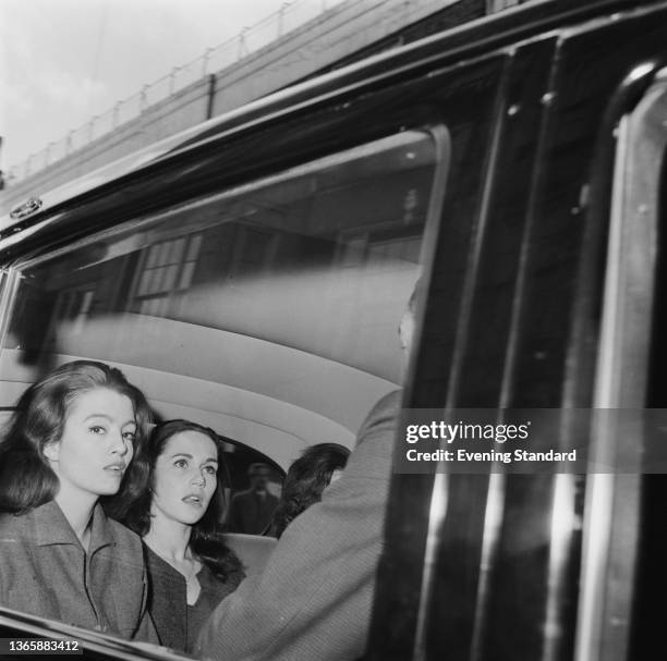 English model Christine Keeler is accompanied by her flatmate Paula Hamilton-Marshall as she appears in court accused of conspiracy to obstruct the...