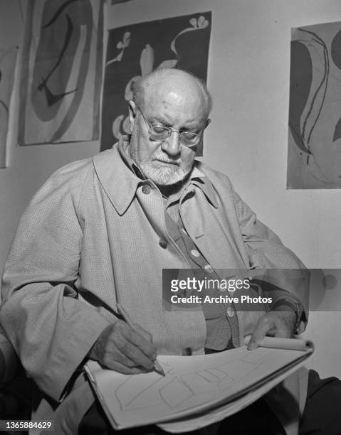 French artist Henri Matisse drawing in his sketchbook at the Villa le Rêve in Vence, France, circa 1948.