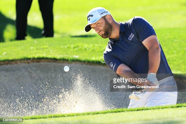 Jon Rahm of Spain plays a bunker shot on the fourth hole during the first round of The American Express at the La Quinta Country Club on January 20,...